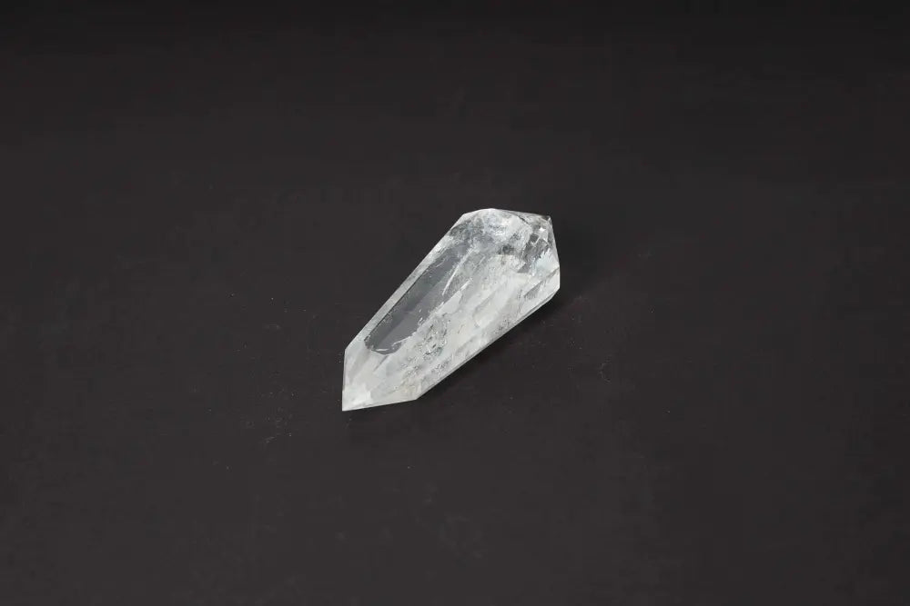 Lemurian Quartz Point crystal with distinct horizontal striations on a dark background, representing ancient wisdom and spiritual energies.