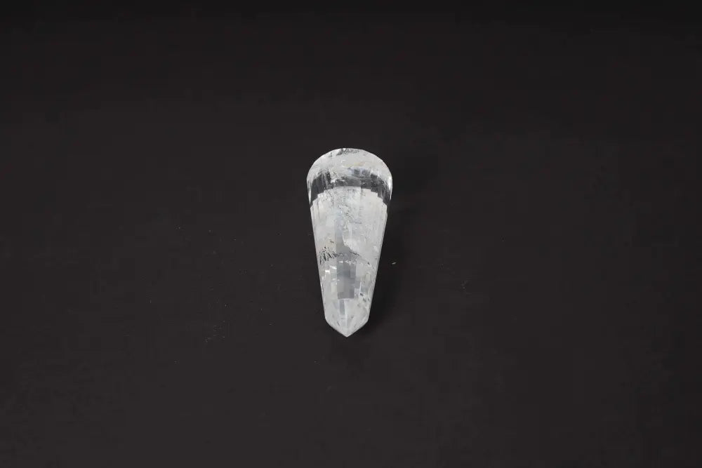 Close-up of a Lemurian Quartz Point crystal with distinct horizontal striations on a dark background, symbolizing ancient wisdom.