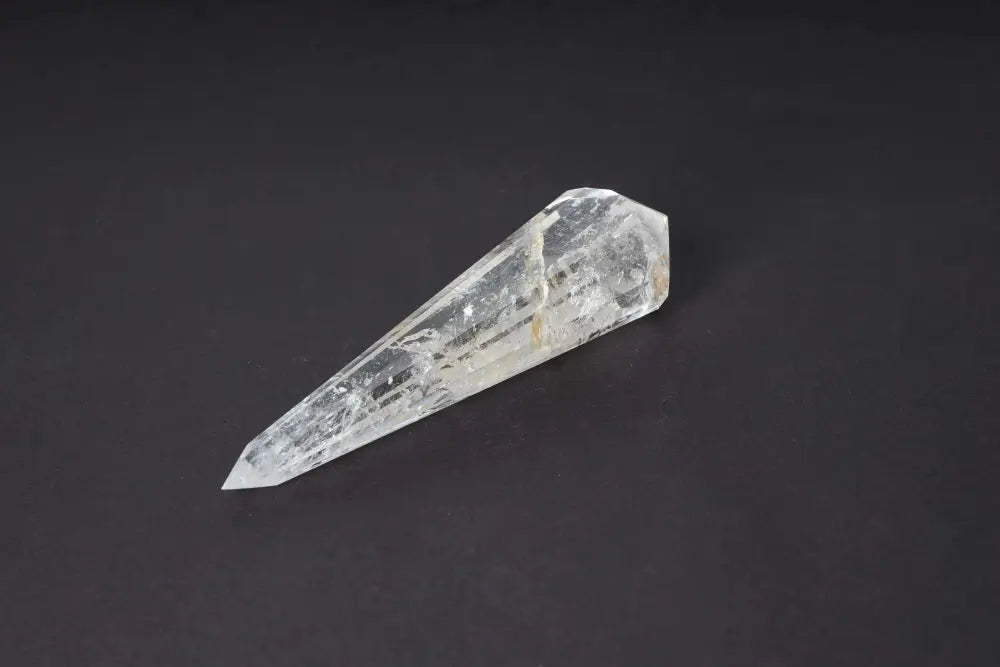 Lemurian Quartz Point crystal with horizontal striations symbolizing ancient wisdom from a lost civilization, on black background.
