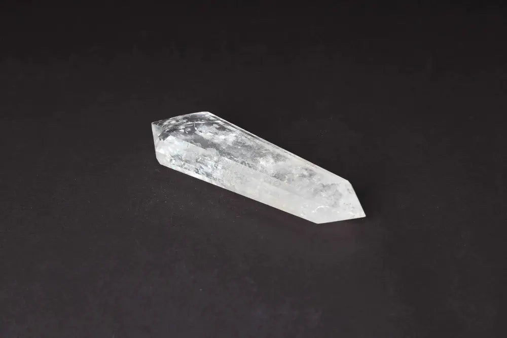 Lemurian Quartz Point on dark background showcasing distinct striations, believed to hold ancient wisdom and spiritual energies.