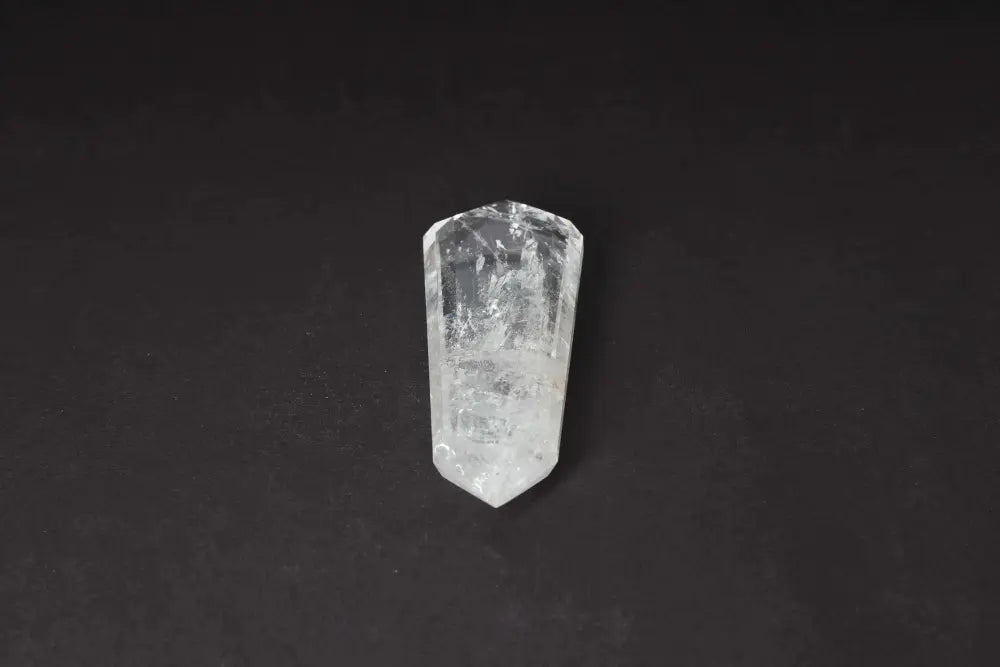 Lemurian Quartz Point crystal with horizontal striations, believed to hold ancient Lemurian wisdom, on a dark background.