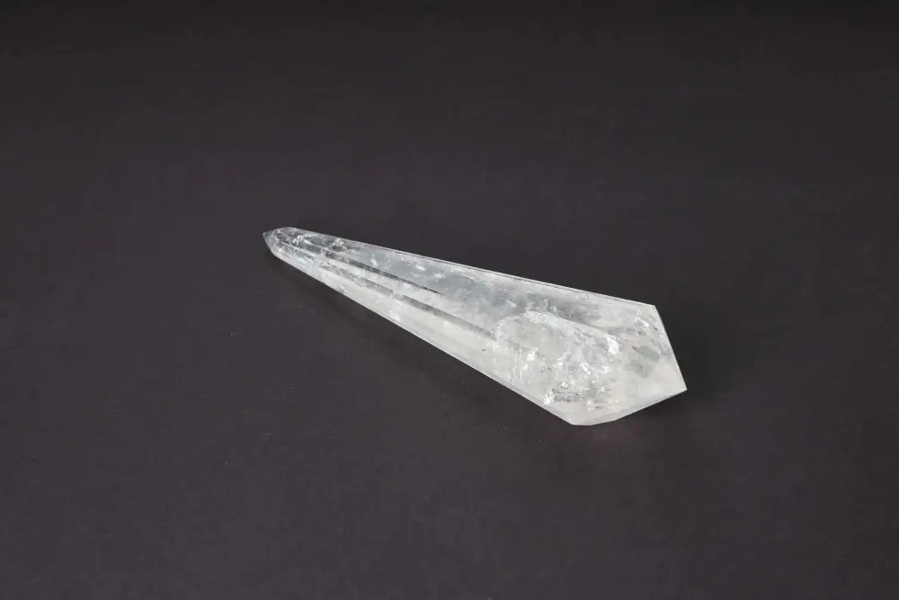 Lemurian Quartz Point with distinct striations, symbolizing ancient wisdom and spiritual connection, on a dark background.