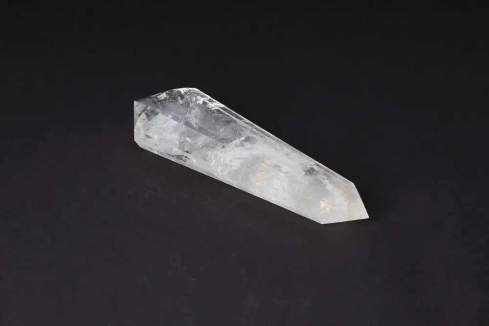 Lemurian Quartz Point crystal with distinct striations on a dark background, believed to carry wisdom from ancient Lemurian civilization.