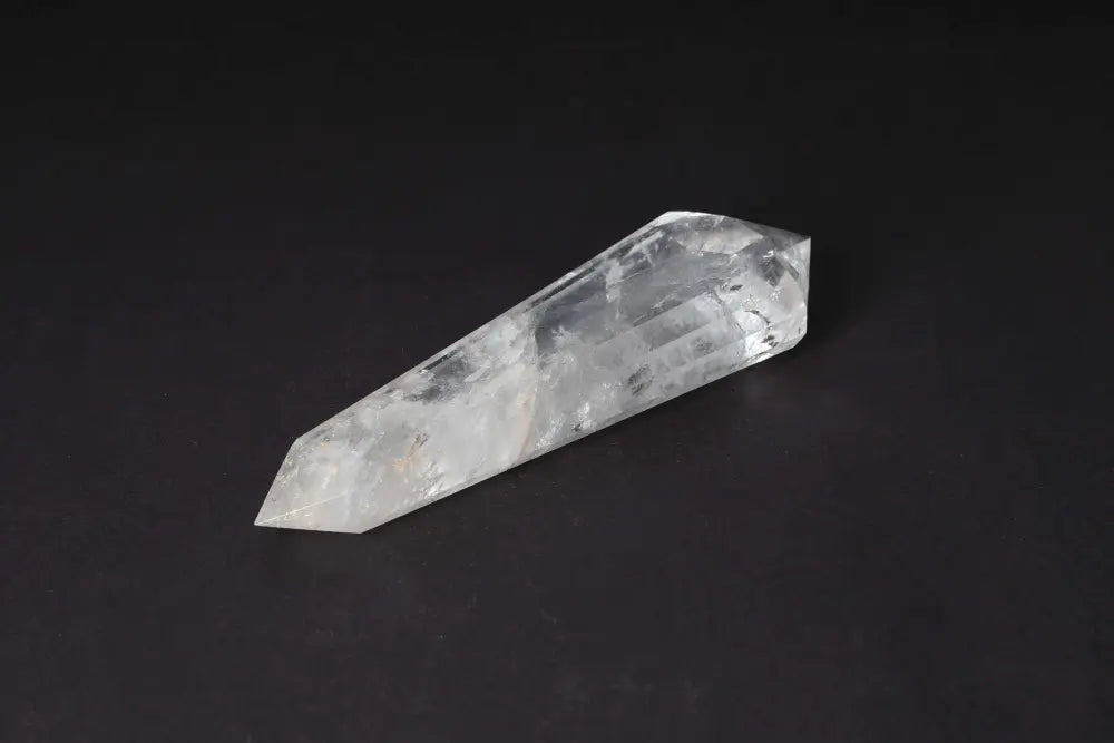 Lemurian Quartz Point with horizontal striations on a black background, representing ancient wisdom and spiritual harmony from lost civilizations.
