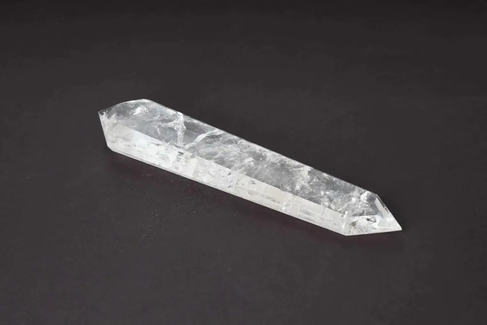 Lemurian Quartz Point crystal with horizontal striations on black background, believed to carry ancient wisdom from the mythical Lemurian civilization.