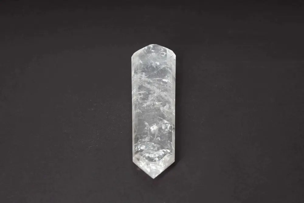 Lemurian Quartz Point crystal against dark background, showcasing horizontal striations and ancient wisdom from Lemurian civilization.