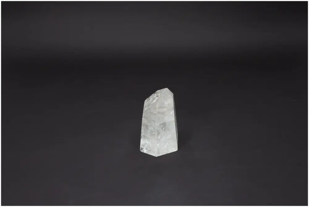 Lemurian Quartz Obelisk from Sylvia Crystals, showcasing luxury and spiritual wellness against a dark background.