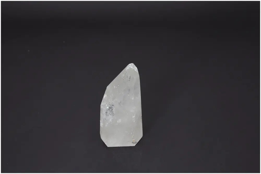 Lemurian Quartz Obelisk by Sylvia Crystals on black background, showcasing clear quartz for spiritual harmony.