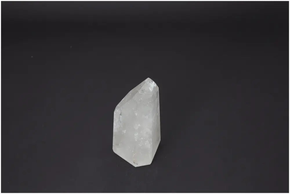 Lemurian Quartz Obelisk by Sylvia Crystals on black background, showcasing its purity and spiritual harmony qualities.