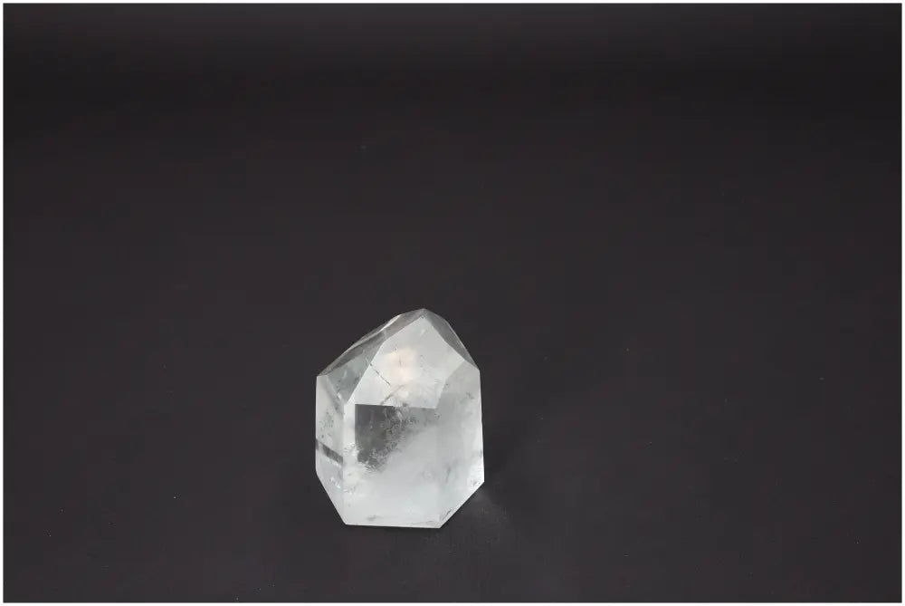 Lemurian Quartz Obelisk on a dark background, showcasing its clarity and geometric shape, ideal for spiritual growth and harmony.