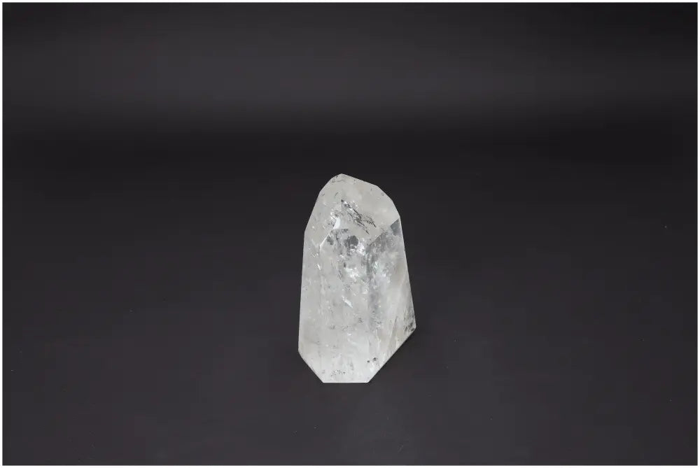 Lemurian Quartz Obelisk from Sylvia Crystals on black background, symbolizing purity and spiritual enhancement.