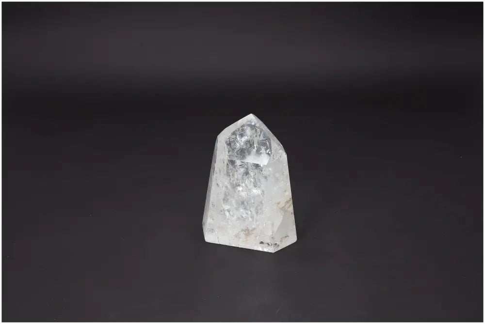 Lemurian Quartz Obelisk on dark background, premium crystal from Sylvia Crystals highlighting elegance and spiritual purity.