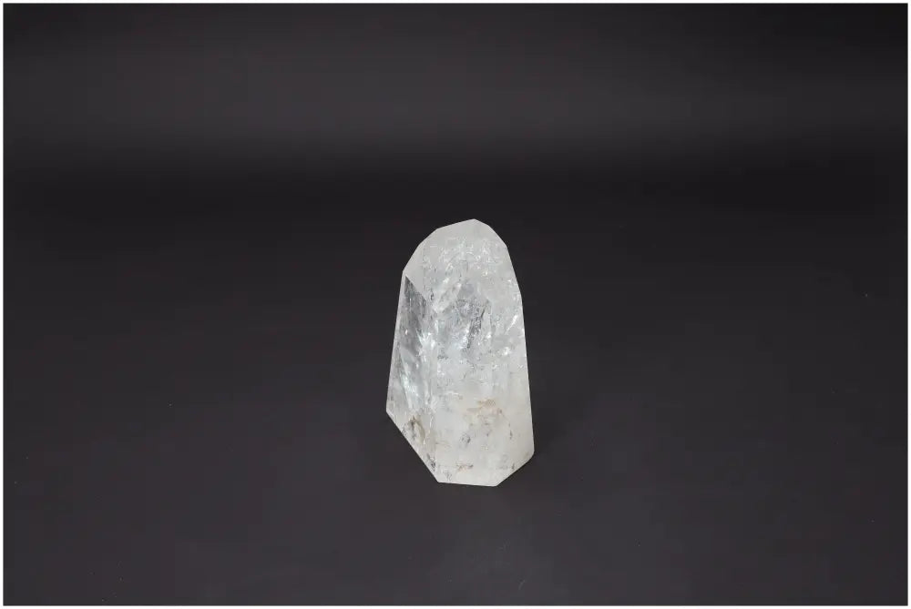 Lemurian Quartz Obelisk on a dark background showcasing its natural crystalline beauty and purity from Sylvia Crystals.