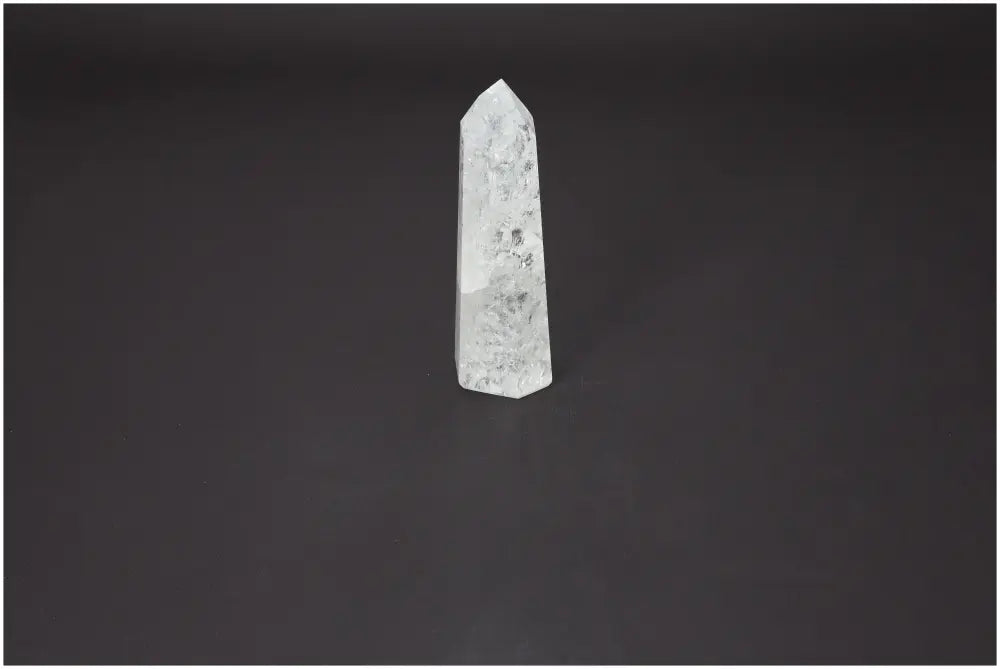 Lemurian Quartz Obelisk for energy harmonization and purification against a dark background.