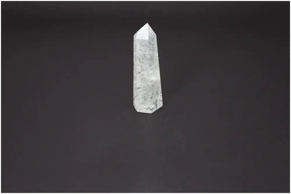 Lemurian Quartz Obelisk for energy purification and harmony by Sylvia Crystals, against a dark background.