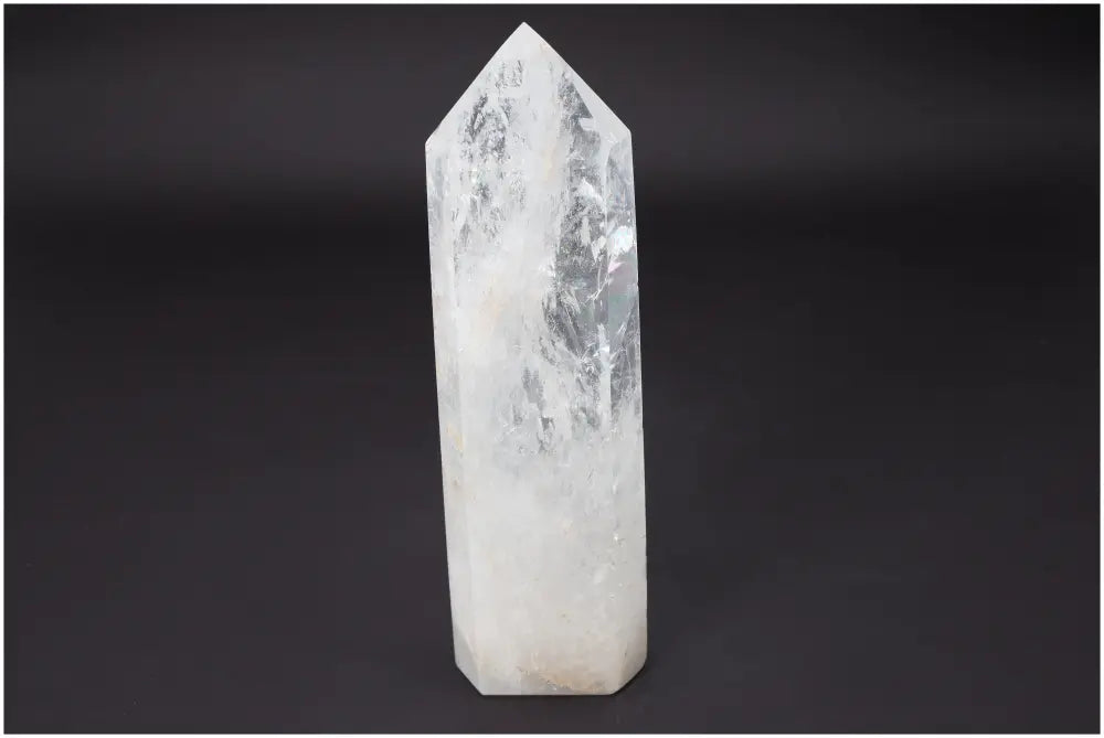 Lemurian Quartz Obelisk by Sylvia Crystals, showcasing luxury and transformative energy against a dark background.
