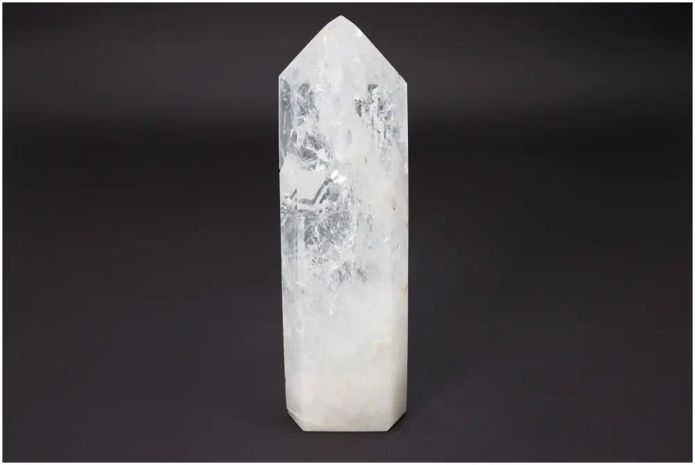 Lemurian Quartz Obelisk from Sylvia Crystals, showcasing transformative energy and purifying properties against a dark background.