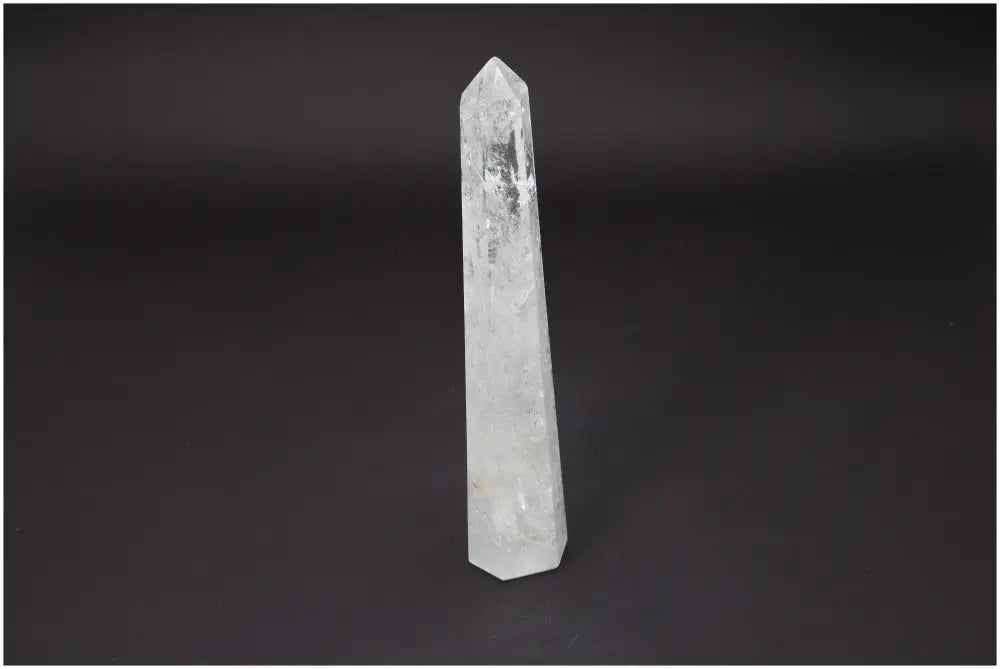 Lemurian Quartz Obelisk on black background, showcasing its clarity and unique energy properties, perfect for spiritual rituals and decor.