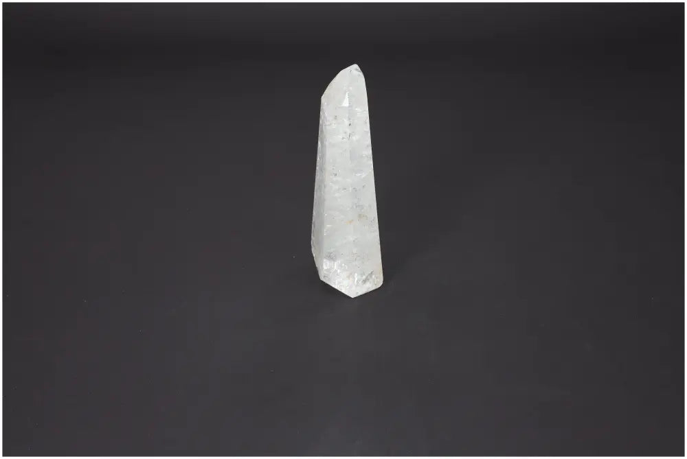 Lemurian Quartz Obelisk on black background, featuring a sleek crystalline structure from Sylvia Crystals for spiritual advancement.