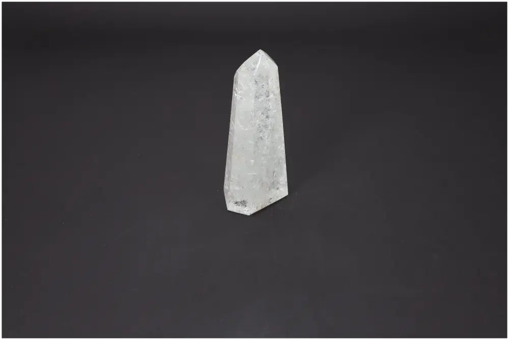 Lemurian Quartz Obelisk from Sylvia Crystals on a dark background, showcasing its clarity and elegance.