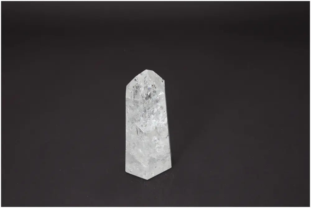 Lemurian Quartz Obelisk on black background, showcasing its unique energetic and spiritual properties linked to chakras and zodiac signs.