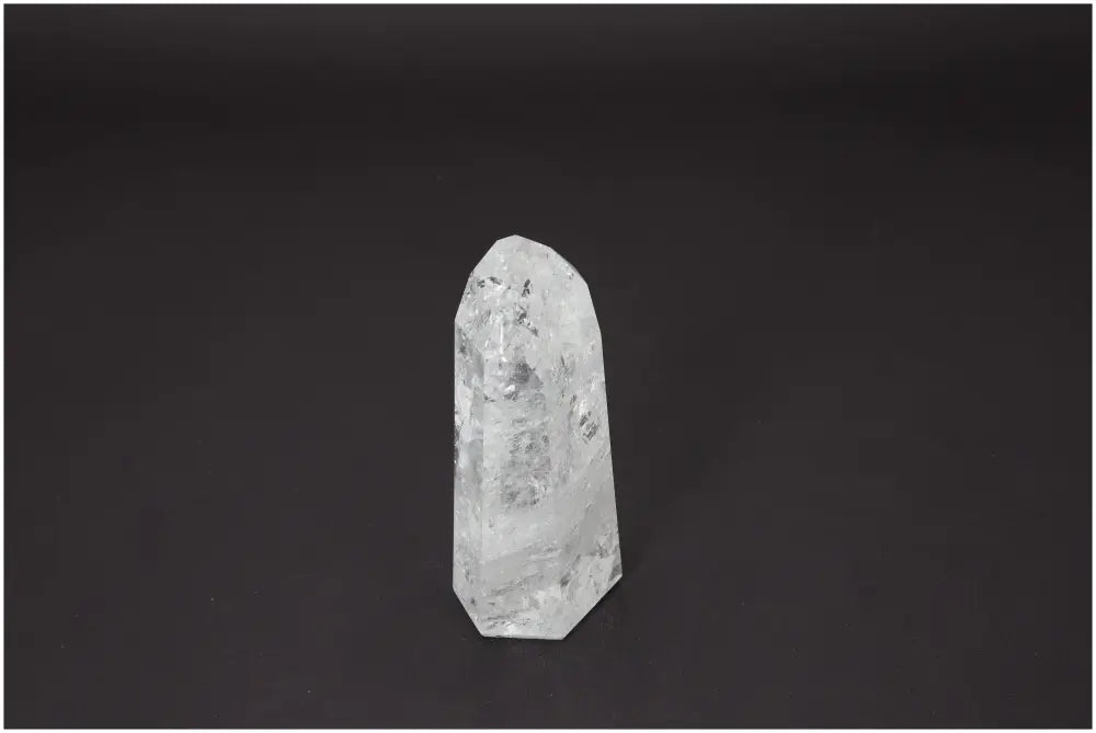 Lemurian Quartz Obelisk on dark background, showcasing its clarity and unique properties for energy and spiritual healing support.