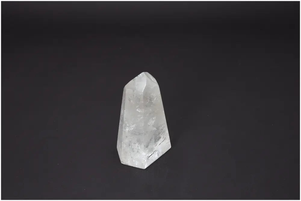 Lemurian Quartz Obelisk on dark background, highlighting its clear and unique energetic properties.