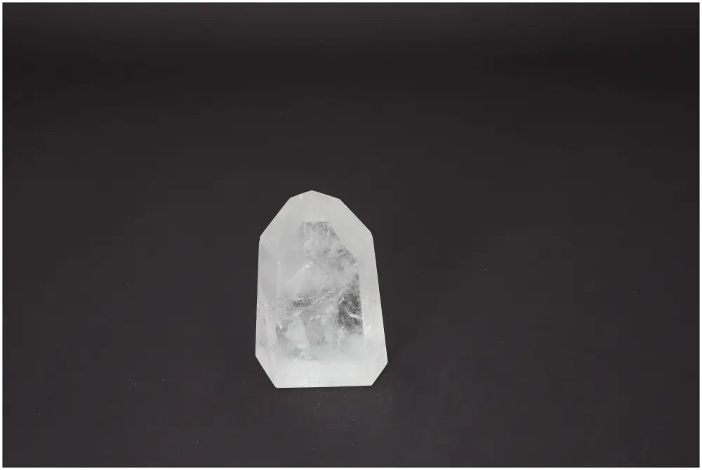 Lemurian Quartz Obelisk on dark background, showcasing its crystal clarity and unique energetic properties for healing and meditation.