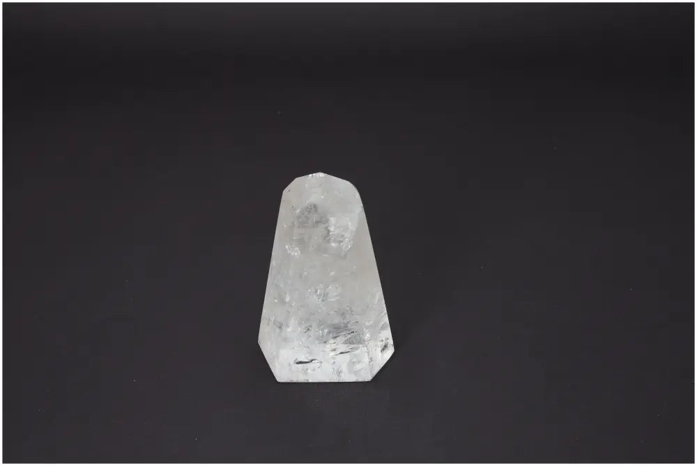 Lemurian Quartz Obelisk against a dark background, showcasing its unique properties associated with chakras and zodiac signs.