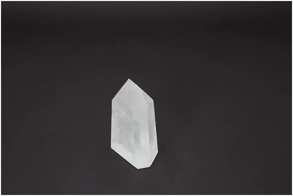 Lemurian Quartz Obelisk against a black background, showcasing natural clarity and spiritual energy properties.
