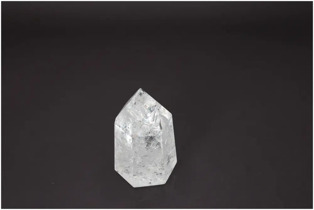 Lemurian Quartz Obelisk with unique energetic properties for chakra and zodiac support against a dark background.