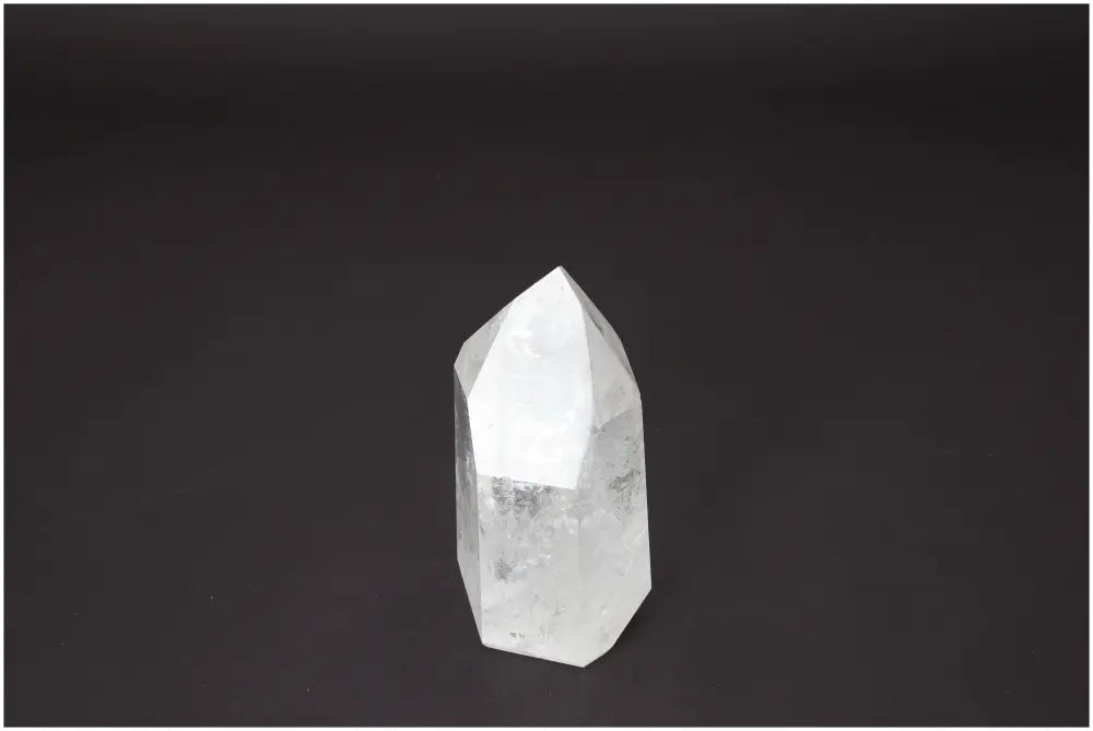 Lemurian Quartz Obelisk with unique energetic properties for chakra balancing and zodiac alignment, set against a dark background.