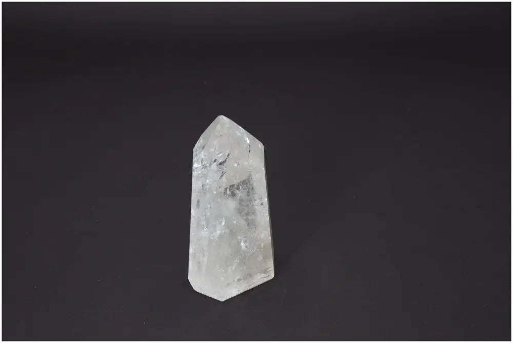 Lemurian Quartz Obelisk standing against a dark background, highlighting its unique spiritual and energetic properties for chakras.