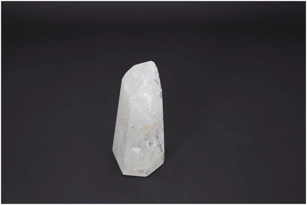Lemurian Quartz Obelisk against a dark background, showcasing its unique properties and energies for chakra and spiritual practice.