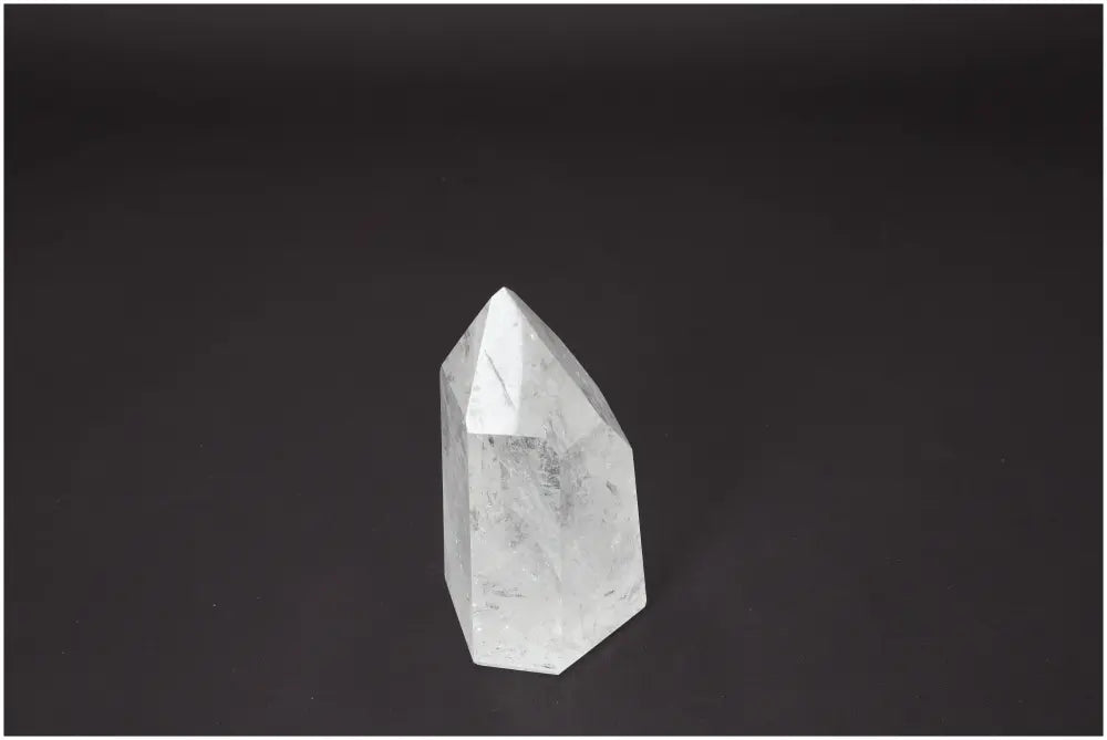 Lemurian Quartz Obelisk on black background, gemstone with unique chakra and zodiac properties enhancing body and soul.