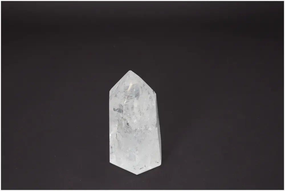 Lemurian Quartz Obelisk crystal against dark background, showcasing clarity and spiritual energy alignment.