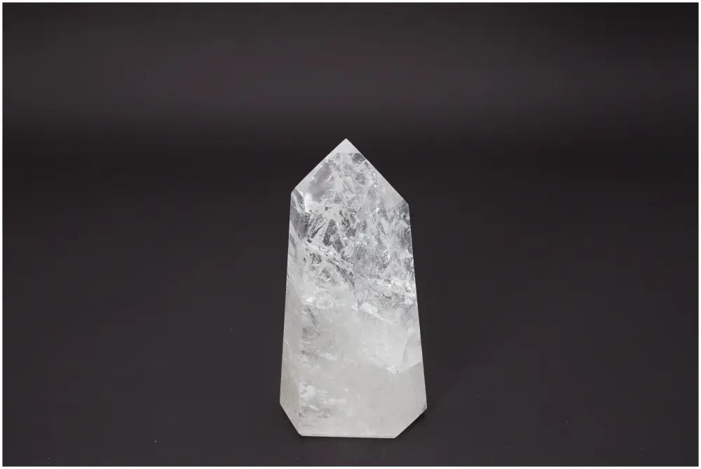 Lemurian Quartz Obelisk enhancing chakra alignment on a dark background; associated with energetic and spiritual properties.