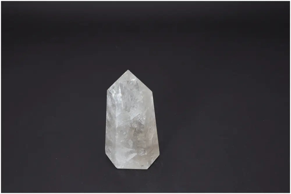 Lemurian Quartz Obelisk for chakra healing and zodiac energy alignment on a dark background.