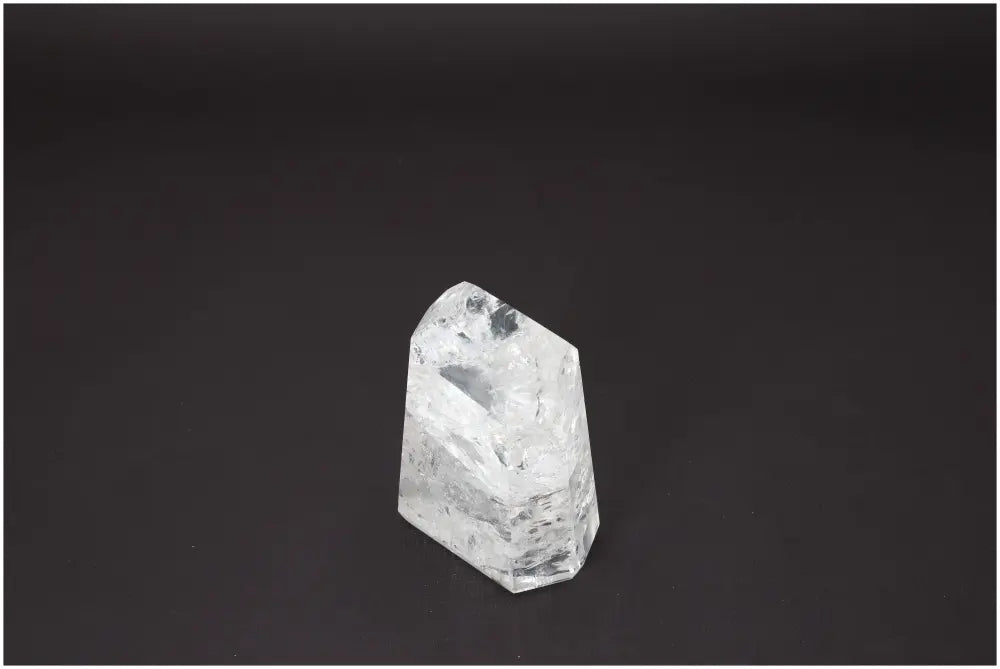 Lemurian Quartz Obelisk on black background, showcasing unique properties and associations with chakras and zodiac signs.