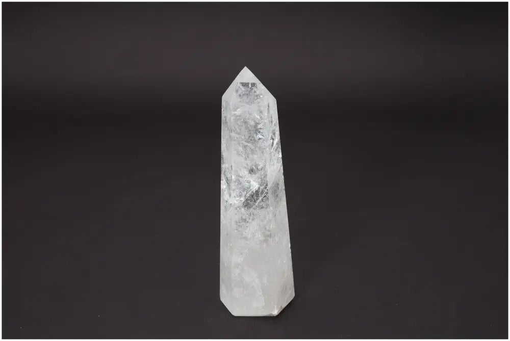 Lemurian Quartz Obelisk on dark background, reflecting unique energies for chakra and zodiac alignment, enhancing spiritual growth.