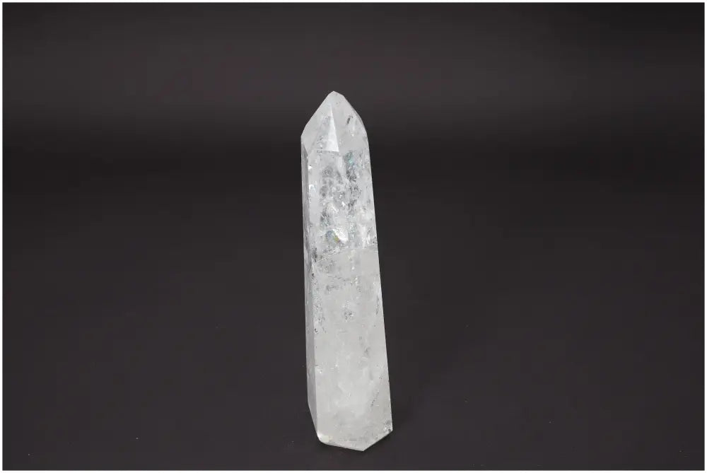 Lemurian Quartz Obelisk for chakra alignment and zodiac energy, clear quartz known for its healing properties against dark background.