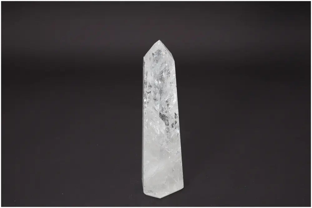 Lemurian Quartz Obelisk against black background, showcasing its unique clarity and spiritual energy properties for chakra healing.