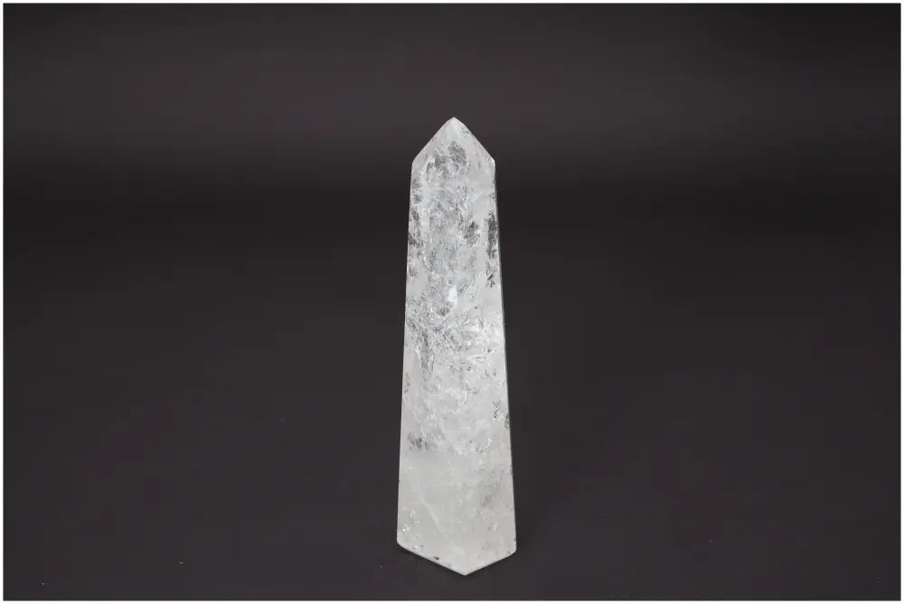 Lemurian Quartz Obelisk against dark background, showcasing its translucent crystal structure and energetic properties.