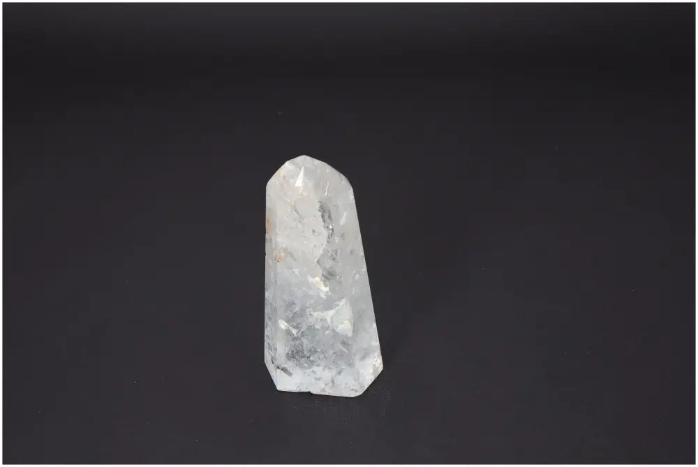 Lemurian Quartz Obelisk reflecting light, known for its chakra alignment and spiritual energy properties, enhancing energetic balance.