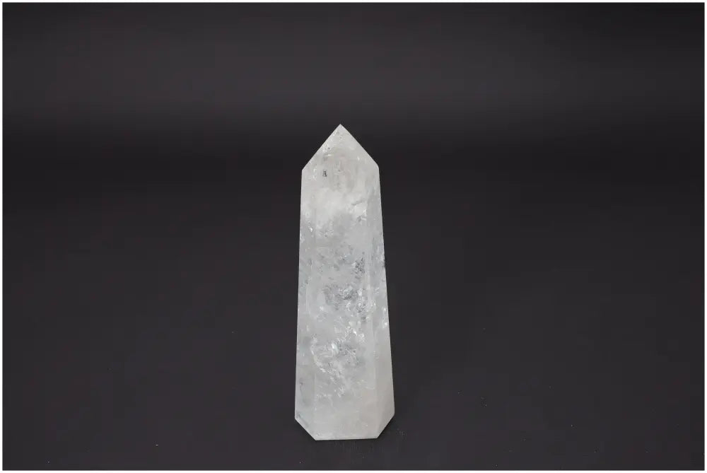 Lemurian Quartz Obelisk on black background, showcasing natural clarity and energy properties for spiritual and chakra healing.
