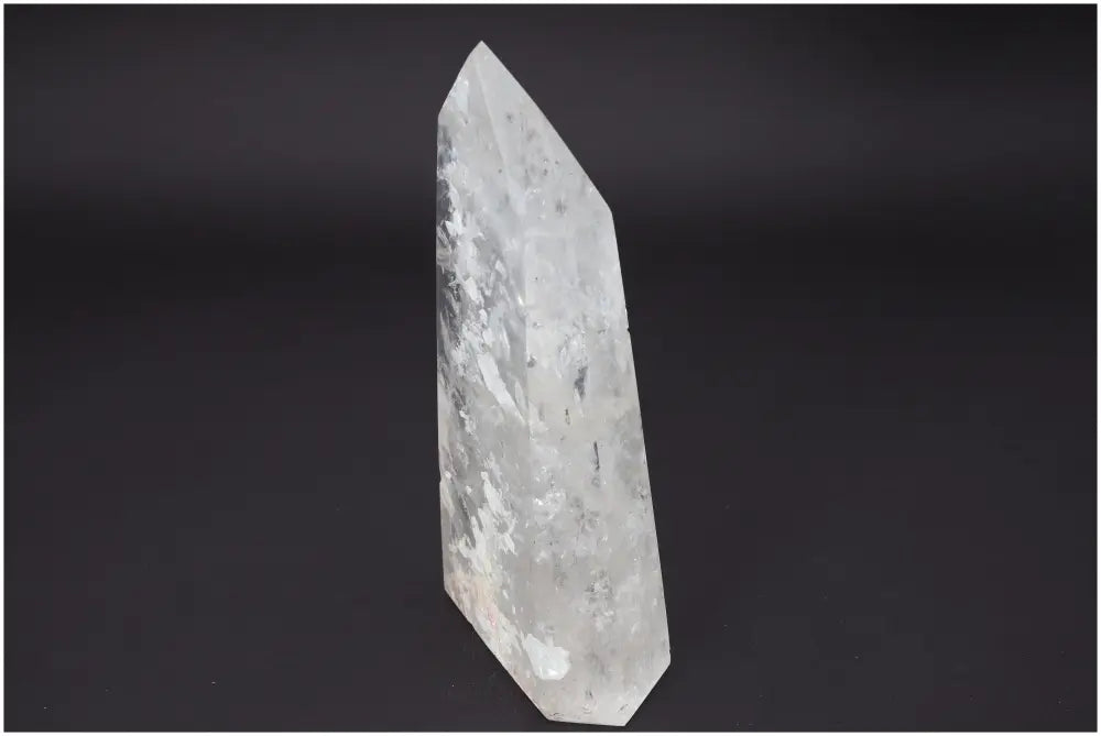 Lemurian Quartz Obelisk crystal with unique properties for chakra and zodiac energy alignment on a dark background.