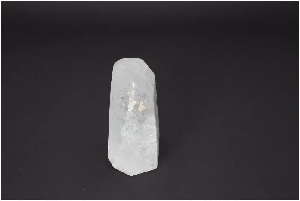 Lemurian Quartz Obelisk with clear crystal structure, enhancing energetic balance, linked to chakras and zodiac signs.