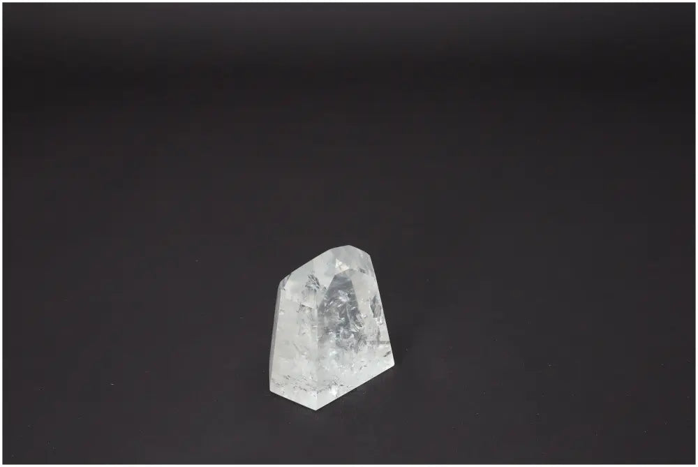 Lemurian Quartz Obelisk showcasing crystal clarity and unique properties for spiritual and energetic alignment on black background.