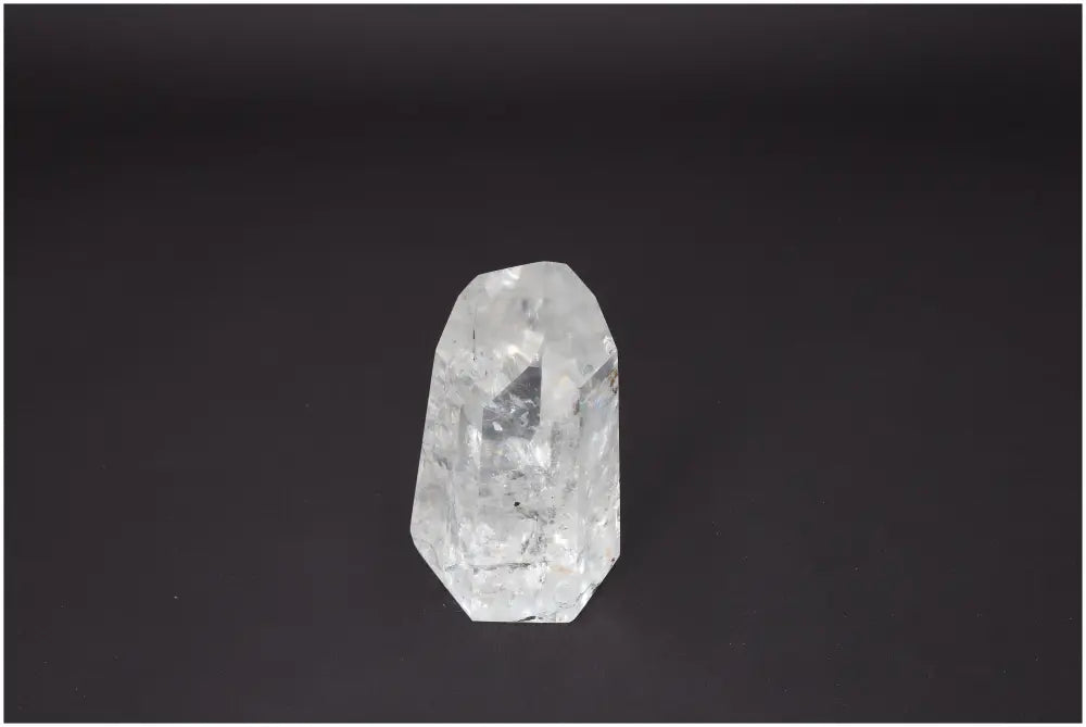 Lemurian Quartz Obelisk against dark background, highlighting clarity and energetic properties for spiritual and chakra support.