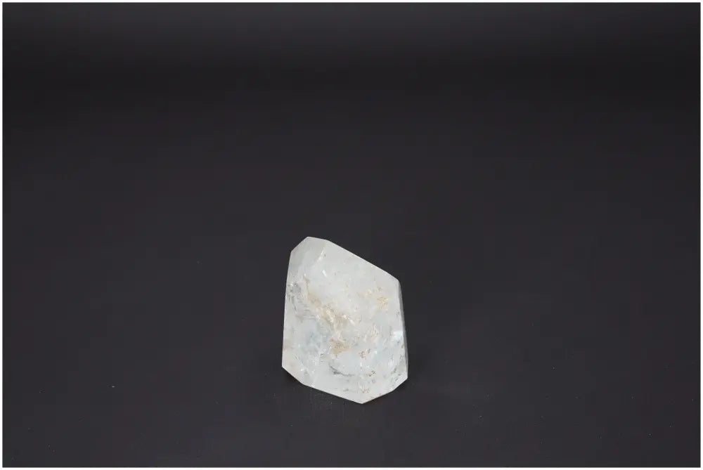 Lemurian quartz obelisk with unique properties supporting chakras and zodiac signs against a dark background
